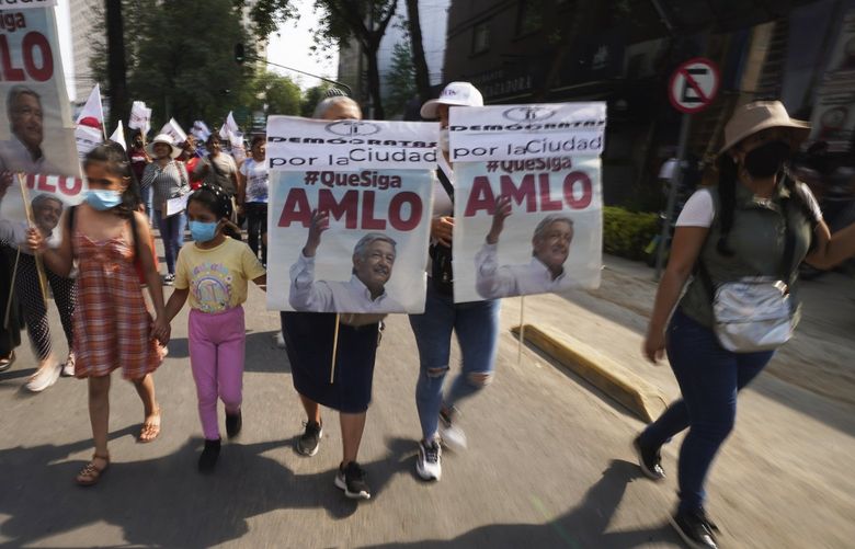 Supporters of Mexican President Andres Manuel Lopez Obrador attend a meeting with Mexico City’s head of government Claudia Sheinbaum and members of the ruling MORENA party to inform on the Energy Reform Bill at the Revolution Monument in Mexico, City, Wednesday, April 6, 2022. (AP Photo/Marco Ugarte) MXMU104 MXMU104