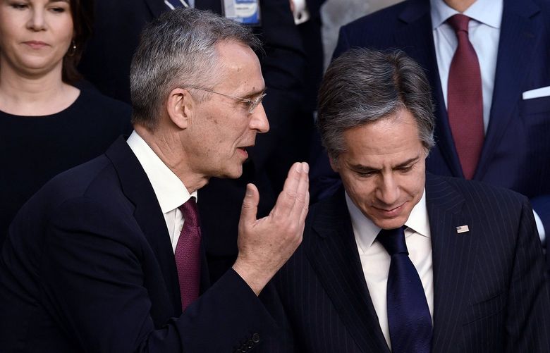 NATO Secretary General Jens Stoltenberg (left) speaks to US State Secretary Antony Blinken (right) before posing for a family photo with other foreign ministers at the NATO Headquarters in Brussels on March 4, 2022.  (Olivier Douliery/AFP via Getty Images/TNS) 44811207W 44811207W