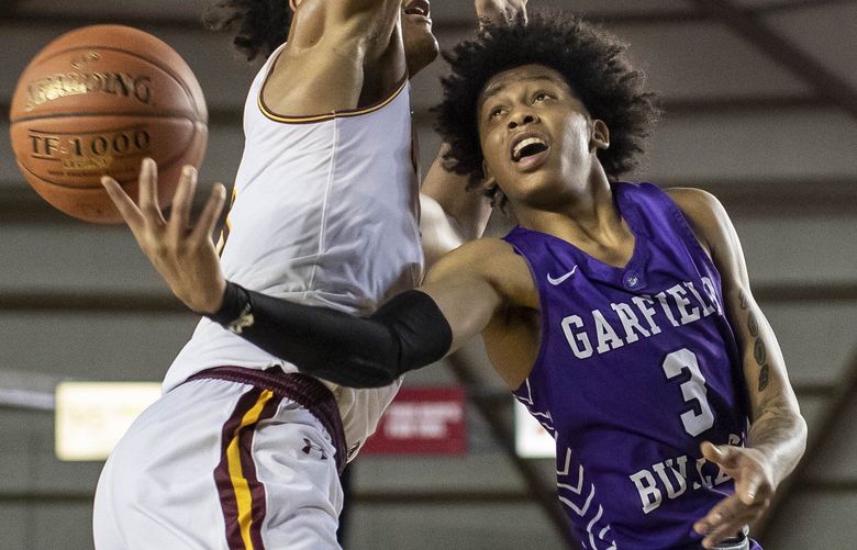 Garfield’s Koren Johnson tries to go around O’Dea’s Paolo Banchero in the 2nd half, and draws the foul from Banchero in the process.  Garfield met O’Dea in the finals of boys 3A State Basketball Saturday, March 7, 2020 at the Tacoma Dome. 213262