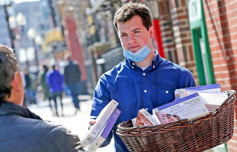 Danny Coakley of North End Waterfront Health gives out free COVID-19 test kits outside of NEW Health’s North End site on March 11, 2022, in Boston. (Matt Stone/MediaNews Group/Boston Herald/TNS) 44926826W
