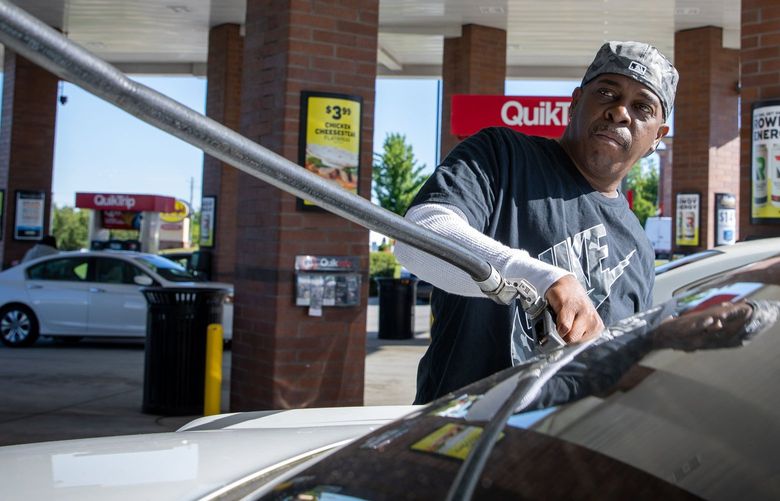 A customer pumps gas in Morrow, Ga., in May 2021.