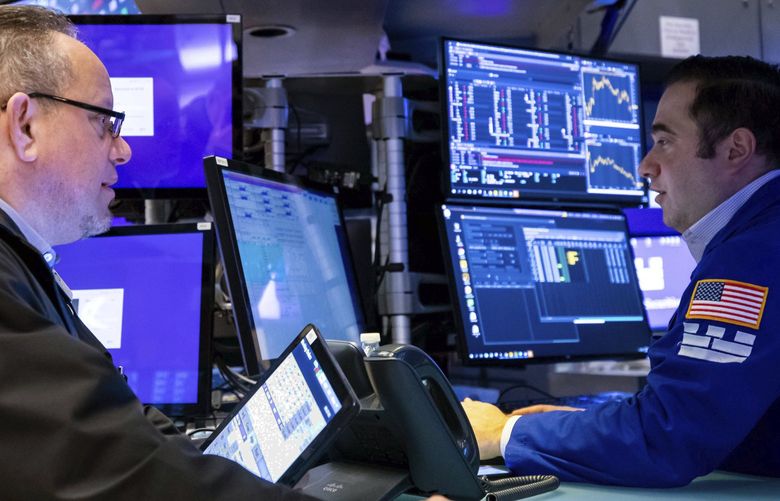 In this photo provided by the New York Stock Exchange, trader Robert Arciero, left, works on the trading floor, Monday, April 11, 2022. Stocks fell in afternoon trading on Wall Street Monday as the market extends a losing streak from last week. (David L. Nemec/New York Stock Exchange via AP) NYRD126 NYRD126