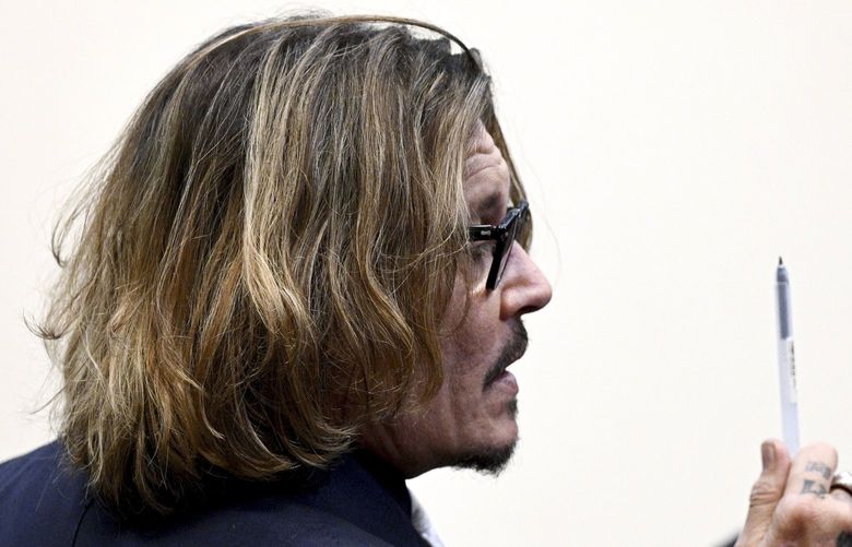 Actor Johnny Depp is seated inside the courtroom at the Fairfax County Circuit Court, April 12, 2022, in Fairfax, Va. A jury in Virginia is scheduled to hear opening statements in a defamation lawsuit filed by Johnny Depp against his ex-wife, Amber Heard. (Brendan Smialowski/Pool Photo via AP) WX428 WX428