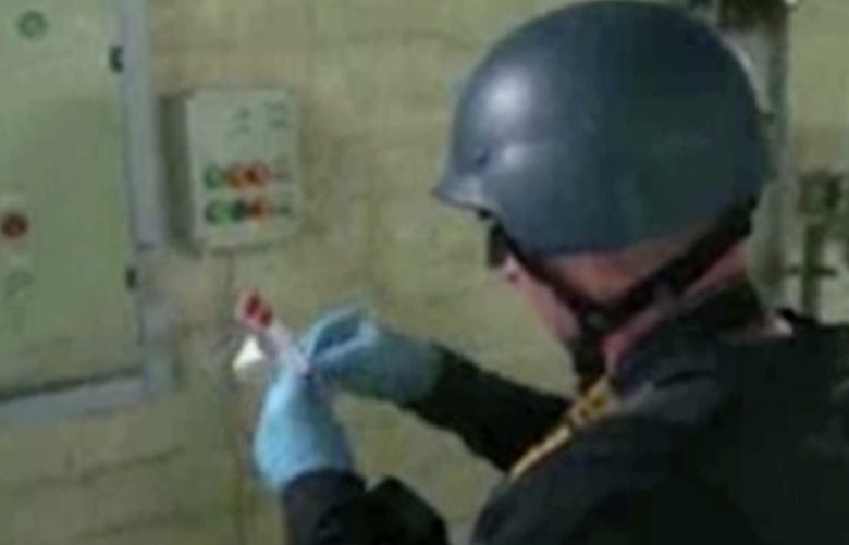 FILE – This image made from video broadcast on Syrian State Television Oct. 8, 2013 purports to show a chemical weapons expert taking samples at a chemical weapons plant at an unknown location in Syria. Legal and moral taboos were shattered with the use of chemical weapons during Syria’s civil war. Hundreds were killed in poison gas attacks widely blamed on President Bashar Assadâ€™s forces under the protection of his chief ally, Russian leader Vladimir Putin. Several years later, concerns are growing that such weapons could be used in Ukraine. (AP Photo/Syrian State Television via AP video, File) XHM505 XHM505