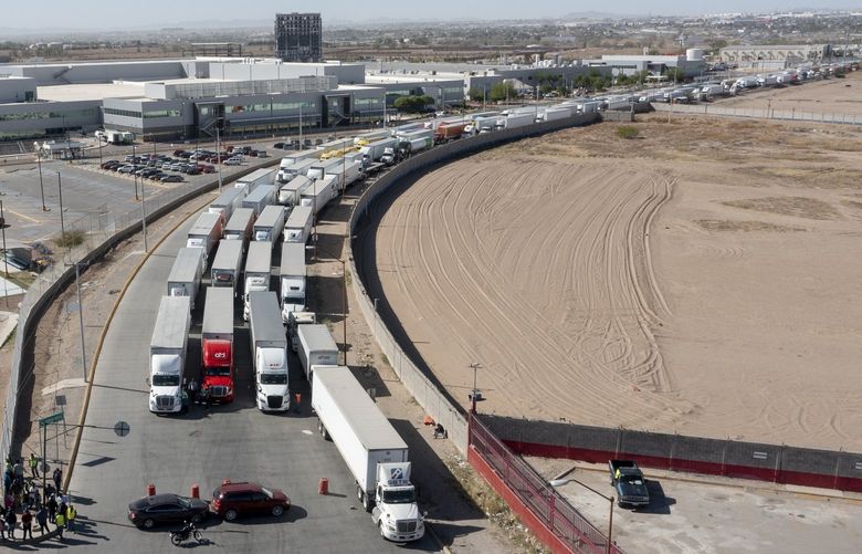 A long line of trucks is seeing stalled at the Zaragoza International Bridge, one of two ports of entry in Ciudad Juarez going into the U.S.on April 12, 2022. The truckers blocked both north and south bound commercial lanes in protest after they have seen prolonged processing times implemented by Gov. Abbott which they say have increased from 2-3 hours up to 14 hours in the last few days. (Omar Ornelas /The El Paso Times via AP) TXELP103 TXELP103