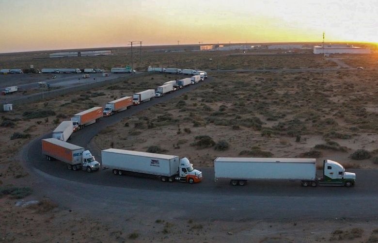Truckers block the entrance into the Santa Teresa Port of Entry in Ciudad Juarez going into New Mexico on April 12, 2022. The truckers blocked the port as a protest to the prolonged processing times implemented by Gov. Abbott which they say have increased from 2-3 hours up to 14 hours in the last few days. (Omar Ornelas /The El Paso Times via AP) TXELP101 TXELP101
