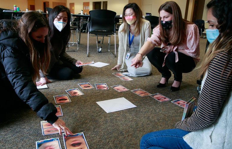 Angela Mitchell, from left, Alyssa Lok, Roxane Chan, Nova Williams, a LETRS facilitator and assistant director of learning services, and Kaylee Cordova build an articulation chart around the speech sounds of English during a workshop on evidenced based reading instruction for Mercer Island K-5 staff and selected secondary staff in Mercer Island Tuesday, March 1, 2022.
219708