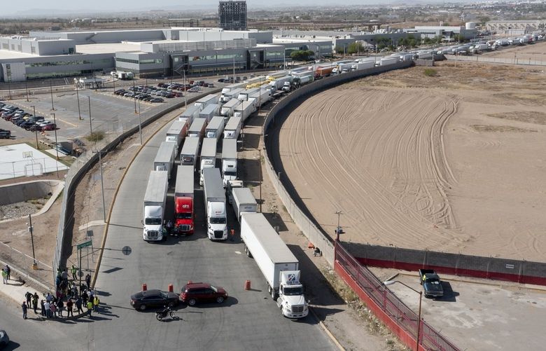 FILE – A long line of trucks is seeing stalled at the Zaragoza International Bridge, one of two ports of entry in Ciudad Juarez going into the U.S.on April 12, 2022. The truckers blocked both north and south bound commercial lanes in protest after they have seen prolonged processing times implemented by Gov. Greg Abbott. His decision to impose additional inspections of trucks entering Texas from Mexico is Abbott’s latest move in an unprecedented foray into border security, which has long been the federal government’s domain. (Omar Ornelas/The El Paso Times via AP, File) TXELP103 TXELP103