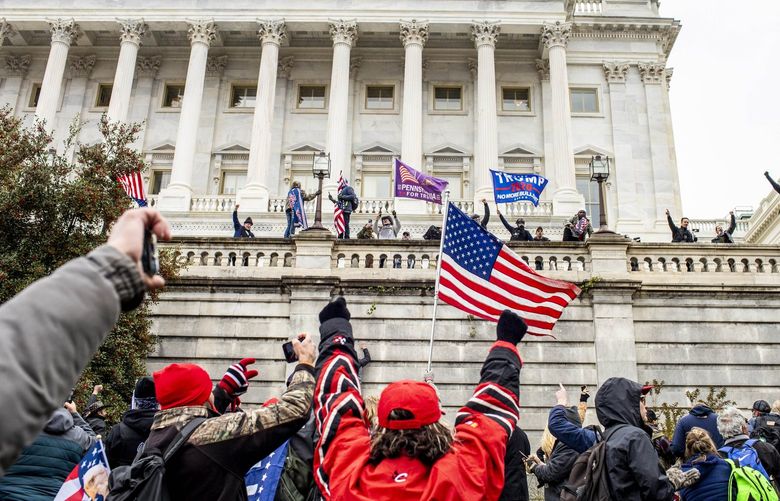 FILE – Protesters outside the U.S. Capitol on the day it was stormed by supporters of former President Donald Trump, in Washington, Jan. 6, 2021. An Ohio man who claimed that Donald Trump was legally responsible for his decision to break into the Capitol and make off with a bottle of bourbon and a coat rack was convicted on Thursday, April 14, 2022, in the first trial connected to the riot to feature a defense that blamed the former president. (Jason Andrew/The New York Times) XNYT179 XNYT179