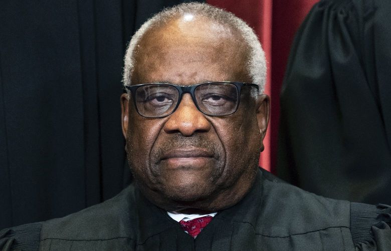 Associate Justice Clarence Thomas sits during a group photo at the Supreme Court in Washington, Friday, April 23, 2021. (Erin Schaff/The New York Times via AP, Pool) NYNYT330