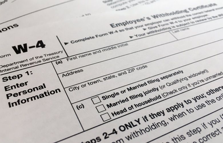 FILE – A W-4 form on Feb. 5, 2020, in New York. Monday is Tax Day, the federal deadline for individual tax filing and payments. The IRS will receive tens of millions of filings electronically and through paper forms. (AP Photo/Patrick Sison, File) WX215 WX215