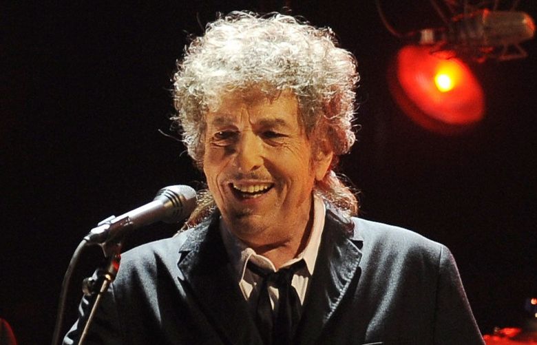 FILE – Bob Dylan performs in Los Angeles on Jan. 12, 2012. Dylan has a new book coming out this fall, a collection of more than 60 essays about songs and songwriters he admires, from Stephen Foster to Elvis Costello. The new book called “The Philosophy of Modern Song,†is scheduled for Nov. 8. (AP Photo/Chris Pizzello, File)
