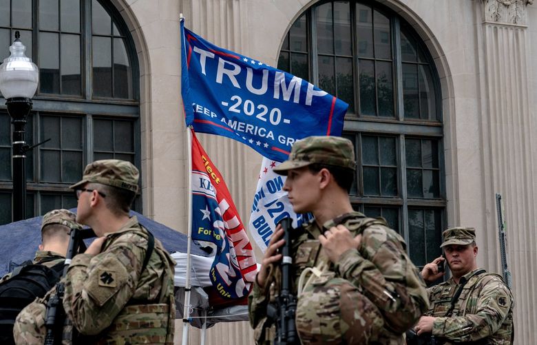 FILE — National Guard troops stand by near a rally for President Donald Trump in Tulsa, Okla., on June 20, 2020. The Insurrection Act, a law from 1807, allows a president to deploy American troops inside the country to put down a rebellion. Lawmakers fear it could be abused by a future president trying to stoke one. (Erin Schaff/The New York Times) XNYT223 XNYT223