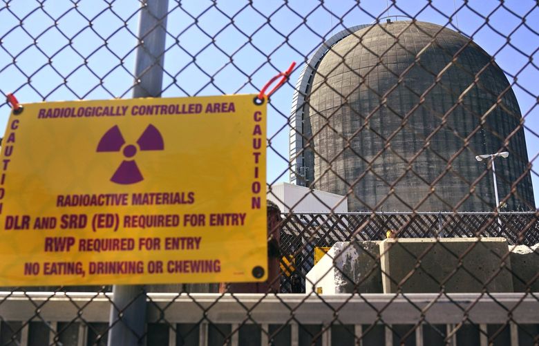 FILEâ€” A sign warning of radioactive materials is seen on a fence around a nuclear reactor containment building on Monday, April 26, 2021, a few days before it stopped generating electricity at Indian Point Energy Center in Buchanan, N.Y. The Biden administration is launching a $6 billion effort to save nuclear power plants at risk of closing, citing the need to continue nuclear energy as a carbon-free source of power that helps to combat climate change. (AP Photo/Seth Wenig, File) BX401 BX401