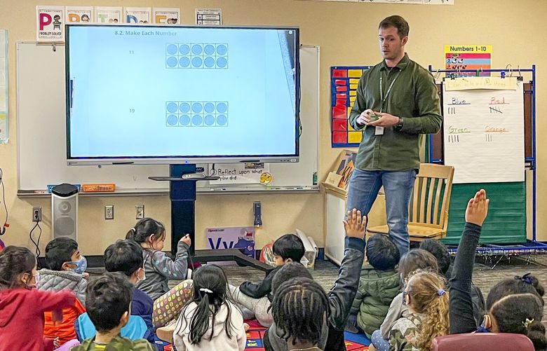 Nathan Roberts, a full-time substitute at Penny Creek Elementary School, teaches a class of kindergarteners how to count.