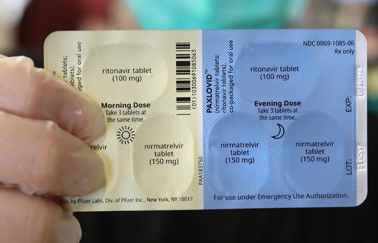 SureCare Pharmacy manager Oscar Uribe shows off a package of Pfizer Paxlovid pills inside of Esperanza Health Center in Chicago’s Brighton Park neighborhood on Thursday, Jan. 13, 2022. Pfizer’s Paxlovid  is a treatment for COVID-19. (Chris Sweda/Chicago Tribune/TNS) 45597390W 45597390W