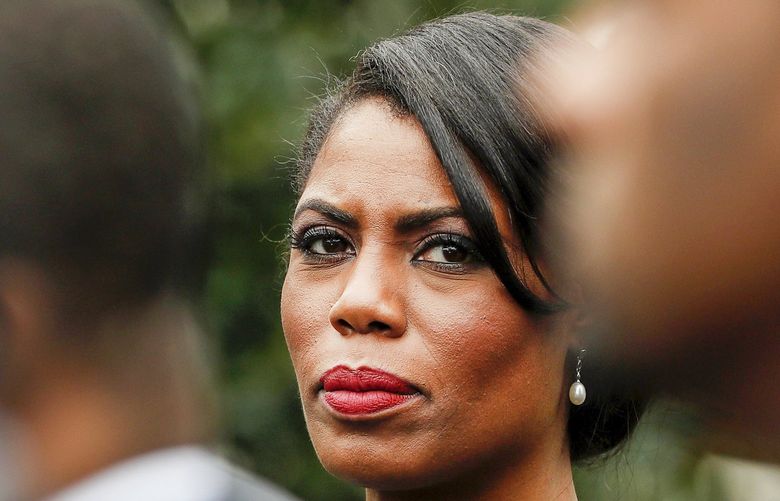FILE – In this Feb. 28, 2017 file photo, White House Director of communications for the Office of Public Liaison Omarosa Manigault Newman stands with the of leaders of Historically Black Colleges and Universities (HBCU) outside the West Wing of the White House in Washington. The White House says former aide Omarosa Manigault Newman has “shown a complete lack of integrity” with her criticism of President Donald Trump in her new book, “Unhinged.” Press secretary Sarah Huckabee Sanders said Tuesday, Aug. 14, 2018, that Trump’s tweets referring to Manigault Newman as “crazed” and a “dog” reflect his “frustration” with her comments. (AP Photo/Pablo Martinez Monsivais) NYET212
