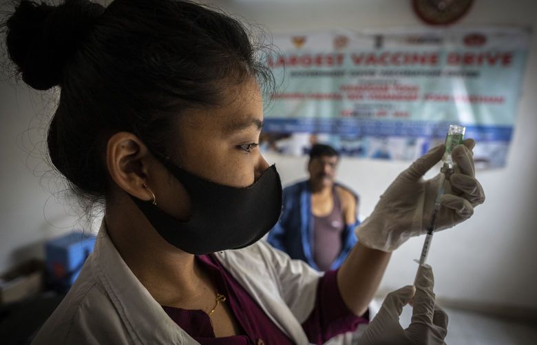 A nurse prepares to administer vaccine for COVID-19 at a private vaccination center in Gauhati, India, Sunday, April 10, 2022. India began offering booster doses of COVID-19 vaccine to all adults on Sunday but limited free shots at government centers to front-line workers and people over age 60. (AP Photo/Anupam Nath) AXN101 AXN101