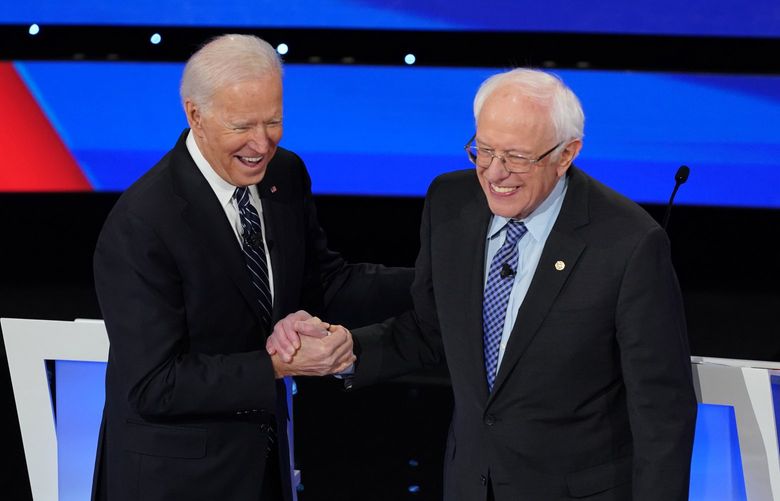 FILE — Former Vice President Joe Biden shakes hands with Sen. Bernie Sanders (I-Vt.) during the Democratic presidential debate at Drake University in Des Moines, Iowa, Jan. 14, 2020. Sanders endorsed Biden as the Democratic nominee for president on Monday, April 13, adding the weight of his left-wing support to Biden’s candidacy and taking a major step toward bringing unity to the party’s effort to unseat President Donald Trump in November. (Tamir Kalifa/The New York Times) XNYTF