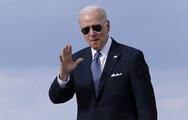 President Joe Biden waves to members of the press as he walks to a motorcade vehicle after stepping off Air Force One, Tuesday, April 19, 2022, at Andrews Air Force Base, Md. Biden is returning to Washington after promoting his infrastructure agenda in New Hampshire. (AP Photo/Patrick Semansky) MDPS107 MDPS107