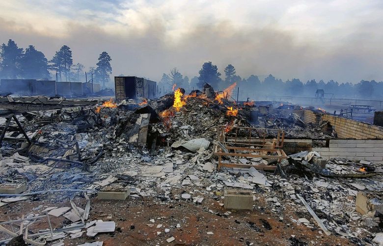 This Wednesday April 20, 2022, photo provided by Bill Wells shows his home on the outskirts of Flagstaff, Ariz., destroyed by a wildfire on Tuesday, April 19, 2022. The wind-whipped wildfire has forced the evacuation of hundreds of homes and animals. (Bill Wells via AP) LA321 LA321