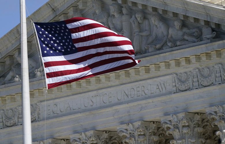 FILE – An American flag waves in front of the Supreme Court building, Nov. 2, 2020, on Capitol Hill in Washington. (AP Photo/Patrick Semansky, File) WX106 WX106
