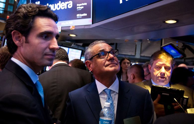 Ernie Garcia III, founder and chief executive officer of Carvana Co., second left, and his father Ernest Garcia II, chairman of Carvana Co., center, stand during the company’s initial public offering (IPO) on the floor of the New York Stock Exchange in New York on April 28, 2017.