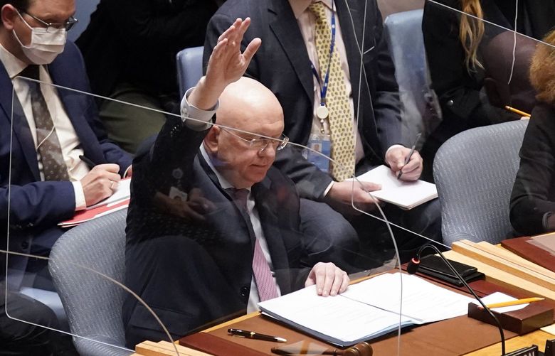 FILE – Russia’s U.N. Ambassador Russia Vasily Nebenzya casts the lone dissenting vote in the United Nations Security Council, Friday, Feb. 25, 2022. Two days into Russia’s attack on Ukraine, a majority of U.N. Security Council members voted to demand that Moscow withdraw. But one thing stood in their way: a veto by Russia itself. Proposals to change the council’s structure or rein in the use of vetoes have sputtered for years. But this time, a new approach appears to be gaining some traction. (AP Photo/Seth Wenig, File) NYJO501 NYJO501