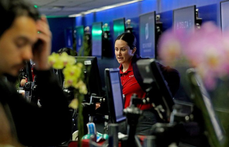 A ticket agent helps passengers at Delta Airlines Terminal 2 at Los Angeles International Airport on Tuesday, April 19, 2022, in Los Angeles. (Gary Coronado/Los Angeles Times/TNS) 45903468W 45903468W