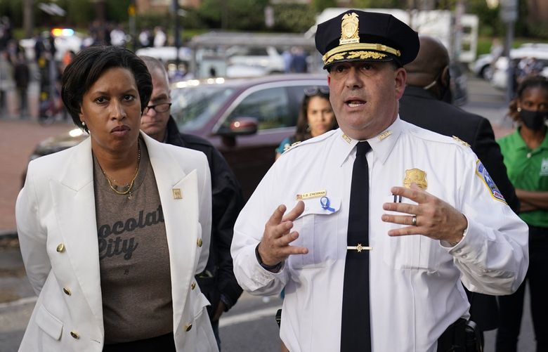 District of Columbia Mayor Muriel Bowser listens as Metropolitan Police Department assistant chief Stuart Emerman speaks near the scene of a shooting Friday, April 22, 2022, in northwest Washington. Police say at least three people were injured in a shooting and city officials are warning people in the area to stay inside because of an “active threat.” Dozens of law enforcement officers responded to the scene near Connecticut Avenue and Van Ness St. in the Van Ness neighborhood of Washington. (AP Photo/Carolyn Kaster) DCCK307 DCCK307