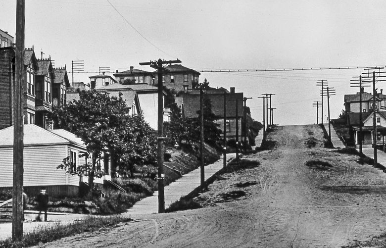 THEN1: The three bay windows of the Wayne Apartments at far left mark the start of Denny Hill’s incline prior to 1903. More than a hundred feet of its slopes were incrementally sluiced away through 1930, leaving behind flatland Belltown. Credit: Paul Dorpat Collection