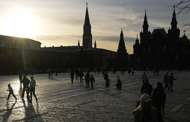 People walk through Red Square during sunset in Moscow, Russia, Thursday, April 14, 2022. (AP Photo/Alexander Zemlianichenko) XAZ109 XAZ109