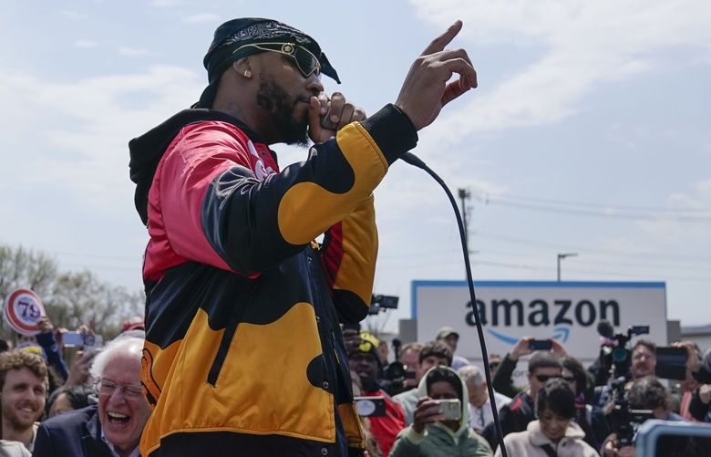 Christian Smalls, president of the Amazon Labor Union, speaks at a rally outside an Amazon facility on Staten Island in New York, Sunday, April 24, 2022. In the aftermath of their hard-won labor victory, Amazon workers in the New York City borough of Staten Island popped Champagne, cheered their victory and danced in celebration. But their jovial attitude will be tested by a company that seems likely to drag its feet to the bargaining table. (AP Photo/Seth Wenig) NYSW110 NYSW110