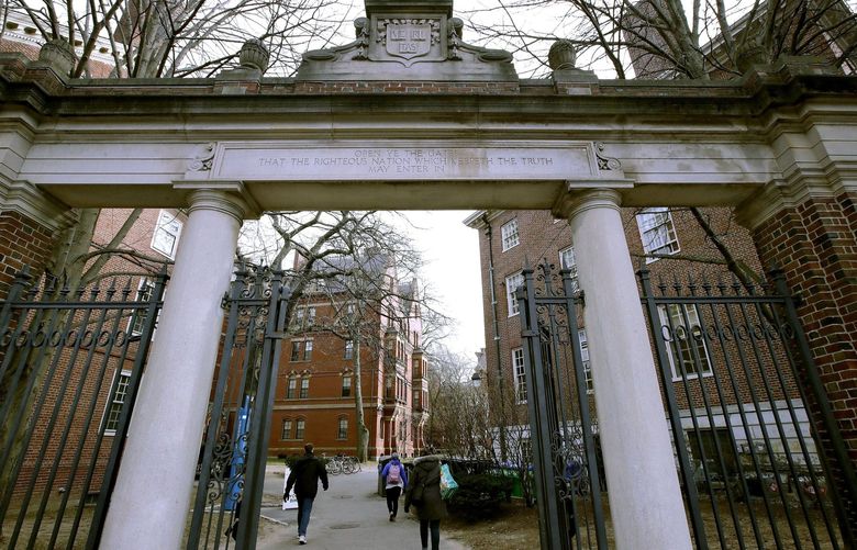 FILE – In this Dec. 13, 2018, file photo, a gate opens to the Harvard University campus in Cambridge, Mass. Harvard President Lawrence Bacow announced Tuesday, April 26, 2022 that the university is committing $100 million to study its ties to slavery and create a “Legacy of Slavery Fund.” (AP Photo/Charles Krupa, File) BX804 BX804