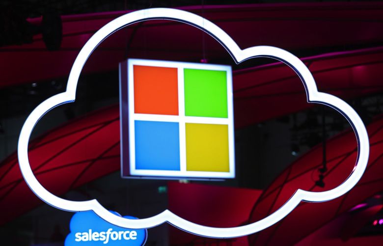  a Microsoft Corp. logo, center, hang beside an illuminated cloud icon at the CeBIT 2017 tech fair in Hannover, Germany, on Sunday, March 19, 2017. Photographer: Krisztian Bocsi/Bloomberg