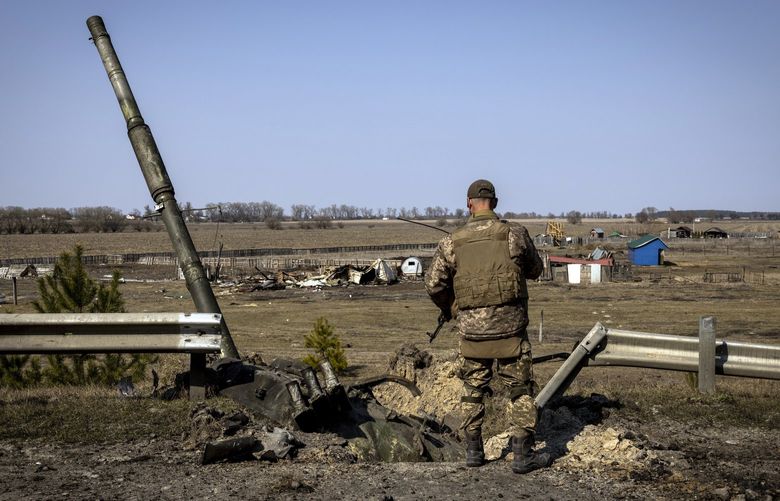 FILE – A Ukrainian soldier looks at the remnants of a Russian T90 tank that was said to have been destroyed using an American-made Javelin missile at a frontline position in the northern region of Kyiv, Ukraine, on March 25, 2022. Washington and its allies are scouring Central Europe and the world to get Ukraine the weapons it needs for the next phase of the war. (Ivor Prickett/The New York Times) XNYT189 XNYT189