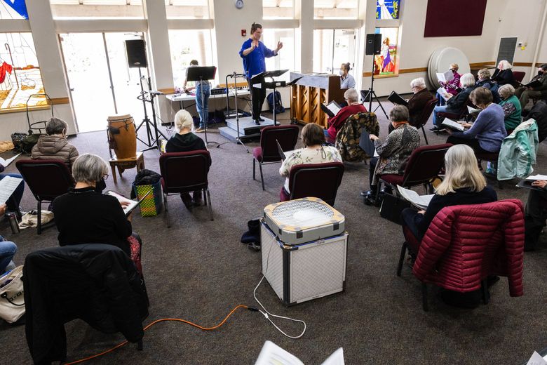 A box fan and air filters make an improvised filtration system that, along with plenty of fresh air, improve air quality for the Skagit Valley Chorale. COVID ravaged the group two years ago, and now members are rehearsing for their first concert since then. (Dean Rutz / The Seattle Times)