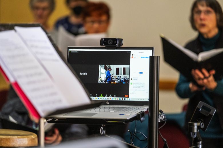 The Skagit Valley Chorale conducted rehearsals via Zoom during the pandemic. Now as members resume in-person rehearsal, some members are for the moment still working remotely. (Dean Rutz / The Seattle Times)
