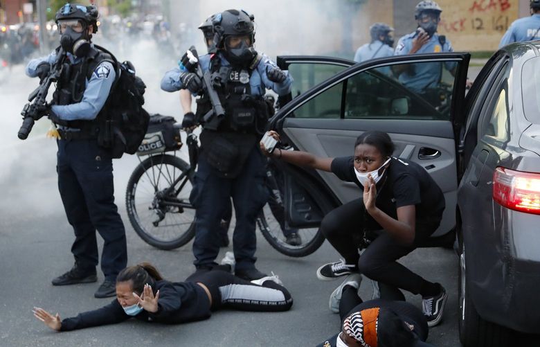 FILE – Motorists are ordered to the ground from their vehicle by police on May 31, 2020, during a protest in Minneapolis over the killing of George Floyd. Almost two years after Floyd died at the hands of four Minneapolis police officers, Minnesota’s Department of Human Rights was set Wednesday, April 27, 2022, to announce findings from its investigation into whether the city police department had a pattern or practice of racial discrimination in policing. (AP Photo/John Minchillo, File) CER503 CER503