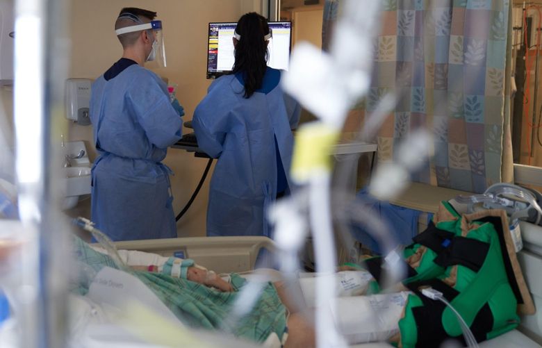 Healthcare workers treat a Covid-19 patient on the Intensive Care Unit at a hospital in Hartford, Conn.