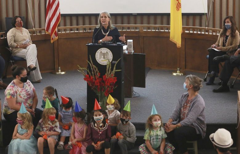 FILE – Gov. Michelle Lujan Grisham announces an increase in child care subsidies on Thursday, July 1, 2021, in Santa Fe, N.M. New Mexico is further increasing its child care subsidies. They’re already the most generous and broadly available in the US. Democratic Gov. Michelle Lujan Grisham says the state will start waiving child care copays to middle-income families starting May 1, 2022. (AP Photo/Cedar Attanasio, File) FX406 FX406