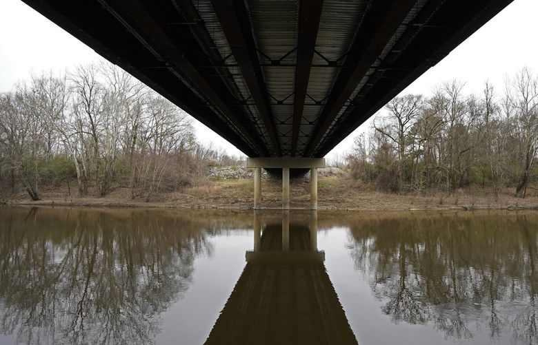 The Tar River flows under the bridge connecting Tarboro and Princeville, N.C., Thursday, March 10, 2022. The river has flooded twice in recent history due to hurricanes, leaving permanent scars on the town of Princeville. (AP Photo/Gerry Broome) NYAG805 NYAG805