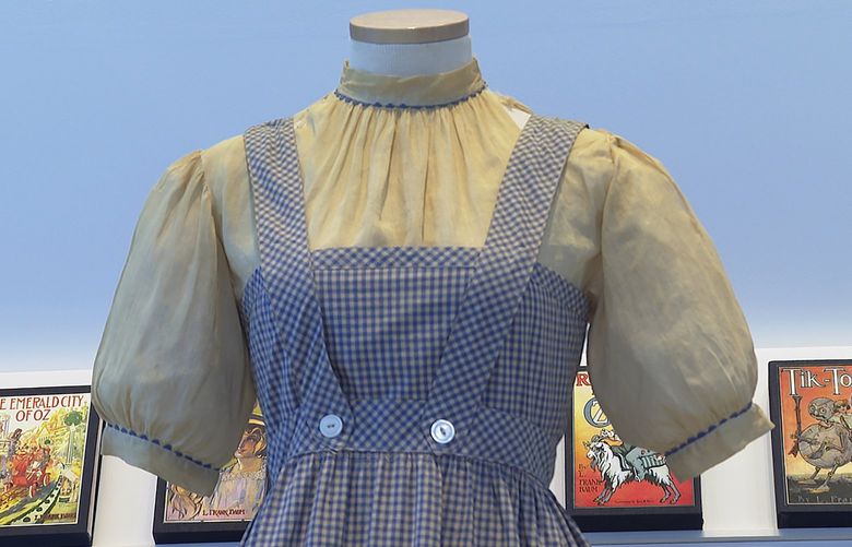 A blue and white checked gingham dress, worn by Judy Garland in the “Wizard of Oz,” hangs on display, Monday, April 25, 2022, at Bonhams in New York. One of the most iconic outfits in American movie history is heading for auction, discovered in a box after decades of being thought lost. The dress was found last year at the Catholic University of America, and is on display in New York City before being put up for sale next month by Bonhams. (AP Photo/Katie Vasquez) NYJJ103 NYJJ103
