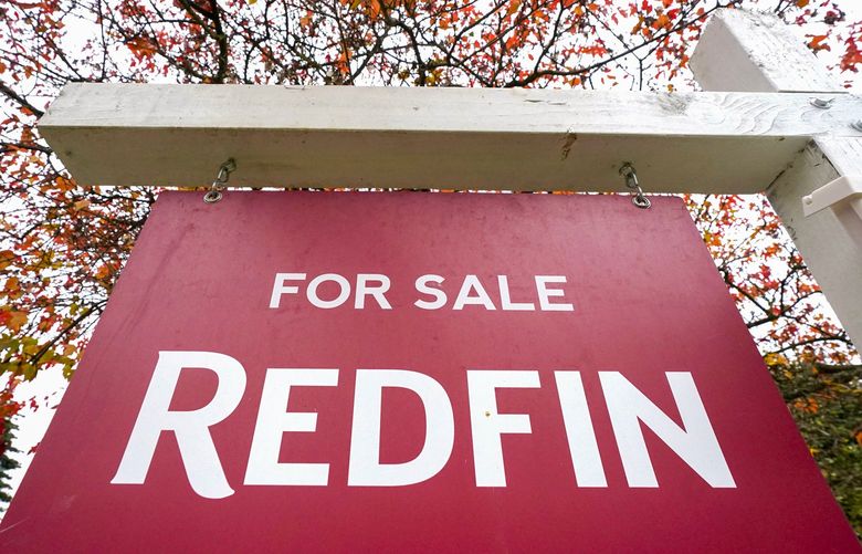 FILE – A Redfin “for sale” sign stands in front of a house on Oct. 28, 2020, in Seattle. The National Fair Housing Alliance on Friday, April 29, 2022, announced a settlement agreement to resolve a lawsuit against Redfin that will expand housing opportunities for consumers in communities of color in major cities. Under the agreement, Seattle-based Redfin will change its minimum housing price policy, alter other practices, and pay $4 million. (AP Photo/Elaine Thompson, File) FX505