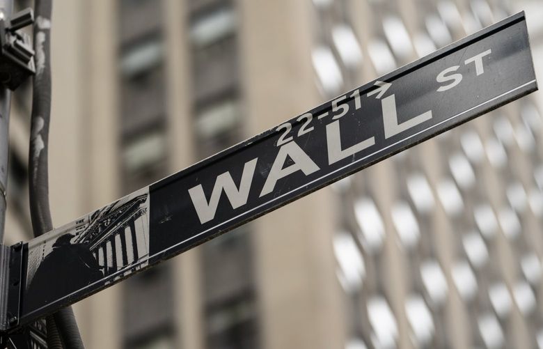 FILE – Wall Street sign near The New York Stock Exchange  2021. (AP Photo/John Minchillo, File) 