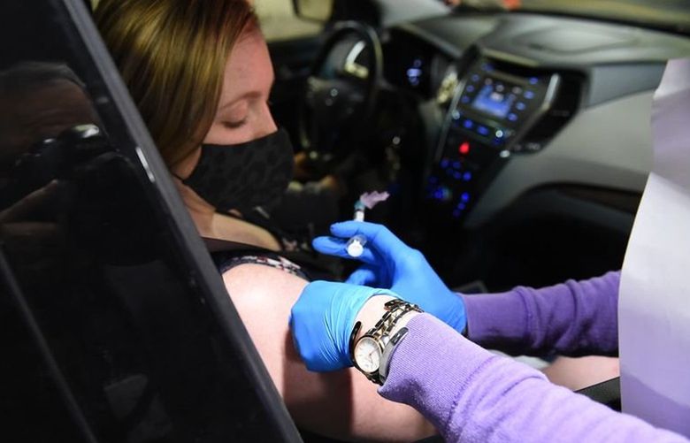Sydney Burritt of Cincinnatus gets her Covid vaccine. The Syracuse VA Medical Center held drive-through Covid-19 vaccination clinics for veterans in its parking garage  Sunday, April 11, and Monday, April 12. The one-shot Johnson & Johnson vaccine was to be distributed at the clinics. 23232864P