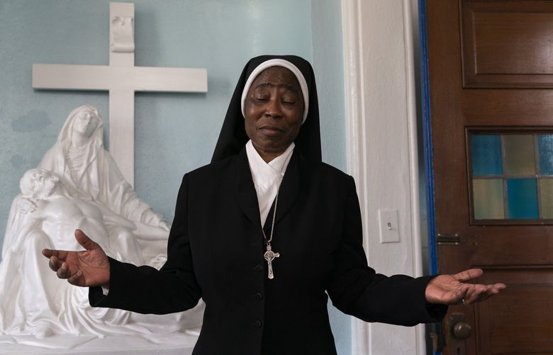 Sister Anthonia Ugwu, a nun with the Oblate Sisters of Providence, works in the chapel at Saint Frances Academy, in Baltimore, Md., Wednesday, April 27, 2022. The Academy, which today educates high school students, was founded in 1828 by Mother Mary Lange, who a year later founded the OSP. The school still educates high schoolers in Baltimore today. (AP Photo/Jacquelyn Martin) NY510 NY510