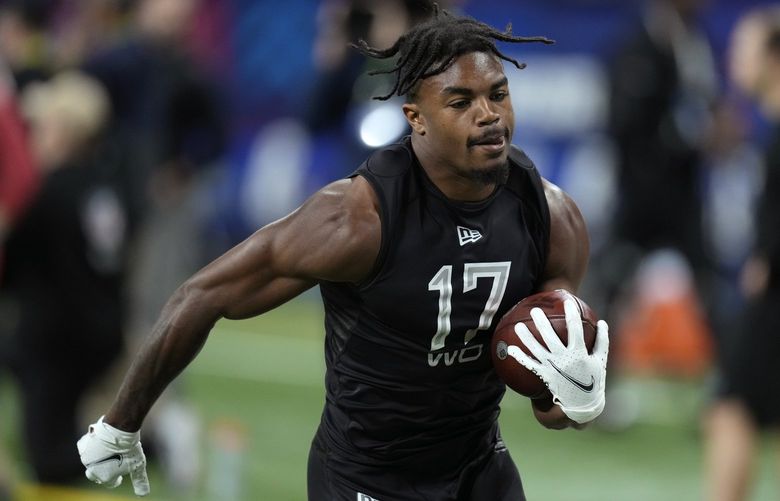 Rutgers wide receiver Bo Melton runs up field after catching a pass during a drill at the NFL football scouting combine, Thursday, March 3, 2022, in Indianapolis. (AP Photo/Charlie Neibergall)