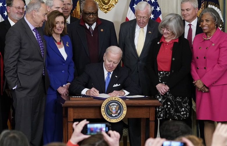 FILE – President Joe Biden signs the Postal Service Reform Act of 2022 in the State Dining Room at the White House in Washington, April 6, 2022. Watching from left are Rep. Stephen Lynch, D-Mass., Sen. Tom Carper, D-Del., Rep. Carolyn Maloney, D-N.Y., Sen. Gary Peters, D-Mich., Senate Majority Leader Chuck Schumer of N.Y., Sen. Rob Portman, R-Ohio, House Speaker Nancy Pelosi of Calif., Rep. James Clyburn, D-S.C., Rep. Steny Hoyer, D-Md., Annette Taylor, Rep. James Comer, R-Ky., and Rep. Brenda Lawrence, D-Mich. Pelosi has tested positive for COVID-19, her spokesman says. (AP Photo/Susan Walsh, File) DCSW307 DCSW307