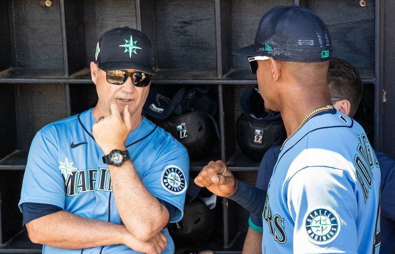 ­Julio Rodriguez talks to manager Scott Servais before the start of Friday’s Spring Training game with the San Diego Padres.

The Seattle Mariners played the San Diego Padres in the first game of Spring Training Friday, March 18, 2022 at Peoria Sports Complex in Peoria, AZ. 219854
